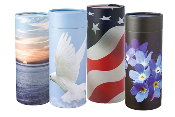 Four cylindrical cremation urns featuring designs of a sunset over the ocean, a white dove, an American flag, and purple flowers.
